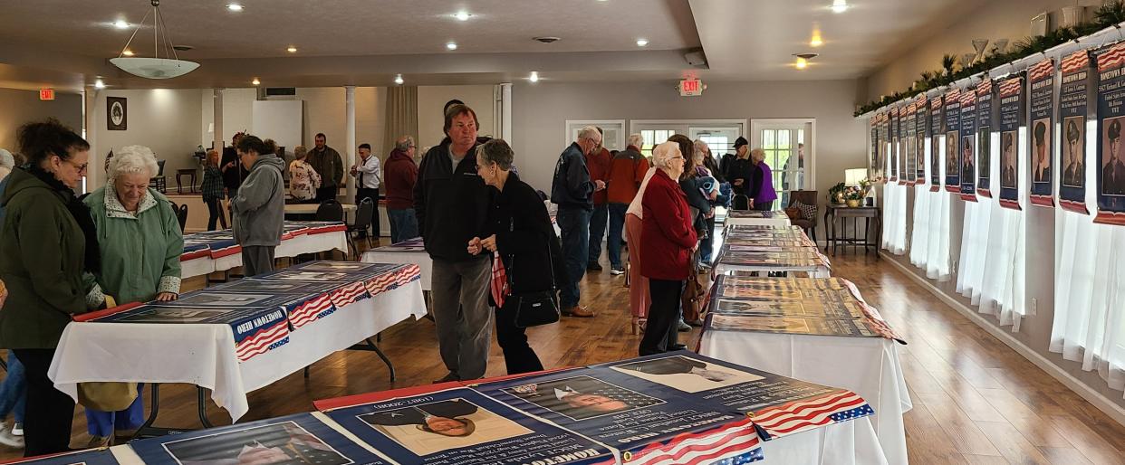 Veterans along with friends and family gathered Tuesday at the Sunroom at the Brick in Frankfort to admire the banners that will hang above the roads this summer honoring veterans from Frankfort and Clarksburg.