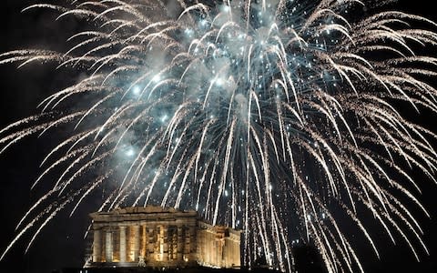 Fireworks explode by the Ancient Acropol - Credit: LOUISA GOULIAMAKI/AFP