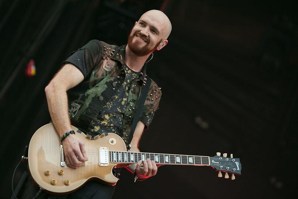 mark sheehan of the script performs at croke park in dublin, playing his guitar