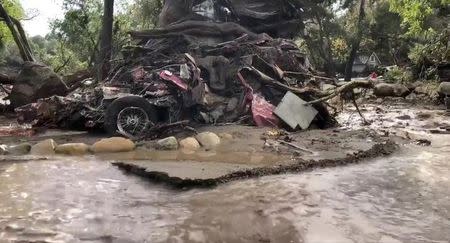 A vehicle is wrapped around a tree after flood and mudslides in Montecito, California, U.S. January 9, 2018 in this photo obtained from social media. Santa Barbara County Fire Department/via REUTERS