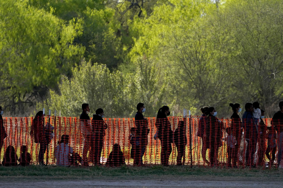 FILE - In this March 19, 2021, file photo, migrants are seen in custody at a U.S. Customs and Border Protection processing area under the Anzalduas International Bridge, in Mission, Texas. U.S. authorities say they picked up nearly 19,000 children traveling alone across the Mexican border in March. It's the largest monthly number ever recorded and a major test for President Joe Biden as he reverses many of his predecessor's hardline immigration tactics. (AP Photo/Julio Cortez, File)