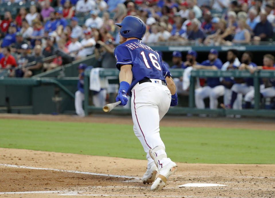 Texas Rangers' Scott Heineman follows through on his first hit in the majors, a single to right, in the fourth inning of the team's baseball game against the Detroit Tigers in Arlington, Texas, Friday, Aug. 2, 2019. The hit came off Tigers starter Tyler Alexander. (AP Photo/Tony Gutierrez)