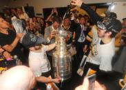 <p>Pittsburgh Penguins center Evgeni Malkin (right) pours a drink into the Stanley Cup after defeating the Nashville Predators in Game 6 of the 2017 Stanley Cup Final at Bridgestone Arena. Credit: Dave Sandford/NHLI/Pool Photo via USA TODAY Sports </p>