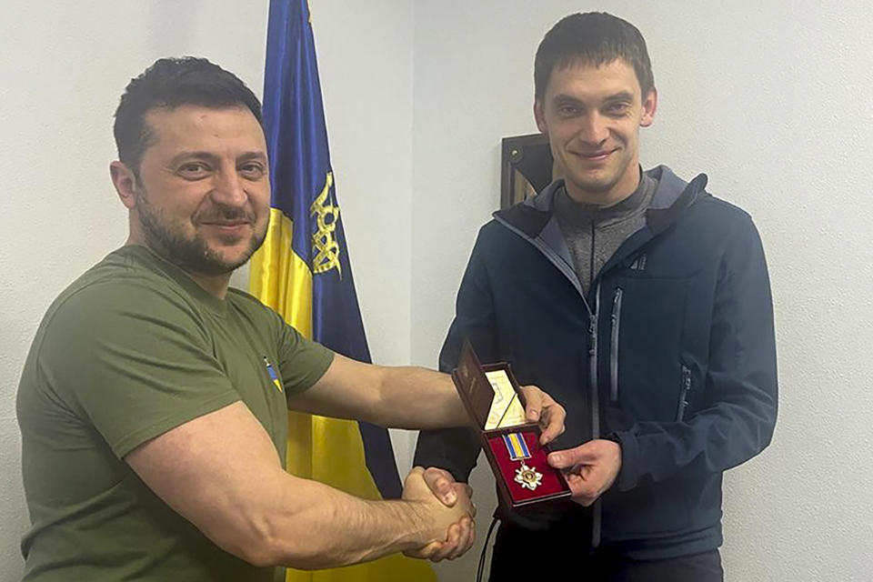 FILE - In this photo provided by the Ukrainian Presidential Press Office, Ukrainian President Volodymyr Zelenskyy, left, awards Ivan Fedorov, the mayor of the southern city of Melitopol, in Kyiv, Ukraine, March 17, 2022. Fedorov, 34, is one of over 50 local leaders who have spent time in Russian captivity since the war began on Feb. 24 in an attempt to subdue towns and cities under Moscow's control. Like many others, he said he was pressured into collaborating with the invaders. (Ukrainian Presidential Press Office via AP, File)