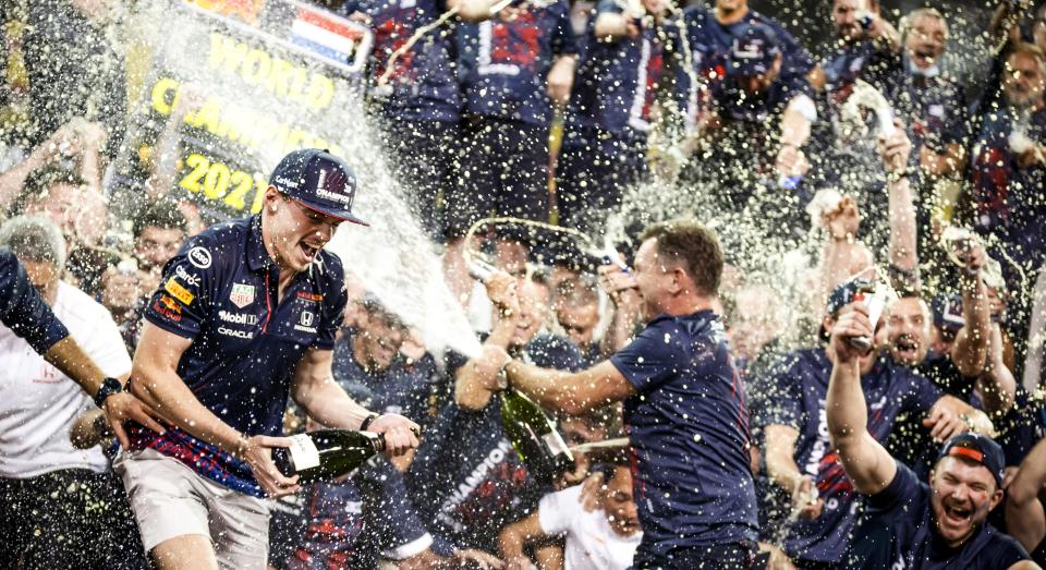 Seen here, Max Verstappen celebrates with his Red Bull team after winning the 2021 F1 drivers' championship.