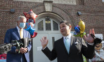 New York City Schools Chancellor Richard Carranza, right, talks at a news conference at the Mosaic Pre-K Center while Mayor Bill de Blasio, left, listens on the first day of school, Monday, Sept. 21, 2020, in New York. The city public schools delayed reopening for two weeks. (AP Photo/Mark Lennihan)