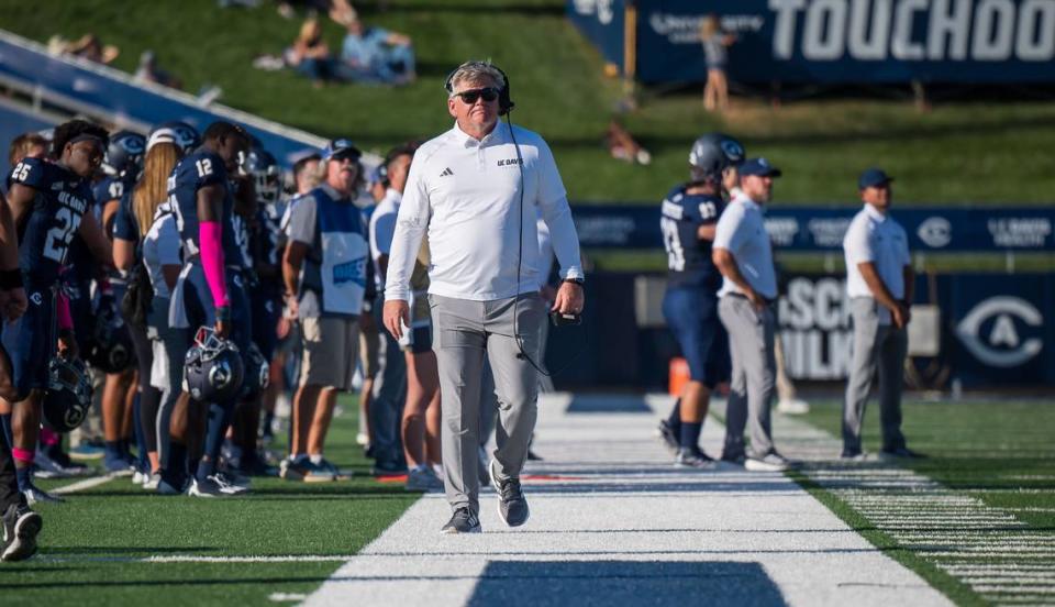 UC Davis Aggies head coach Dan Hawkins walks the sideline during a timeout in the first half as they play the Montana Grizzlies at the NCAA college football game Saturday, Oct. 7, 2023, at UC Davis Health Stadium.