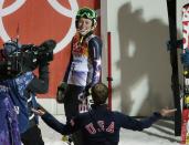 United States' Mikaela Shiffrin is congratulated by a member of the U.S. ski team after winning the gold medal in the women's slalom at the Sochi 2014 Winter Olympics, Friday, Feb. 21, 2014, in Krasnaya Polyana, Russia. (AP Photo/Charlie Riedel)