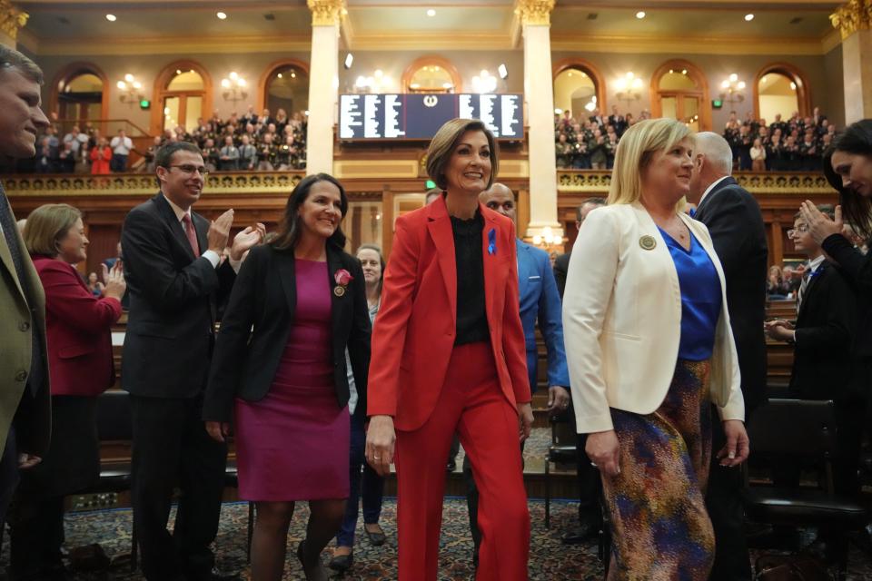 Gov. Kim Reynolds is escorted into the Iowa House of Representatives to give the annual Condition of the State address at the Iowa State Capitol, Tuesday, Jan. 9, 2024.