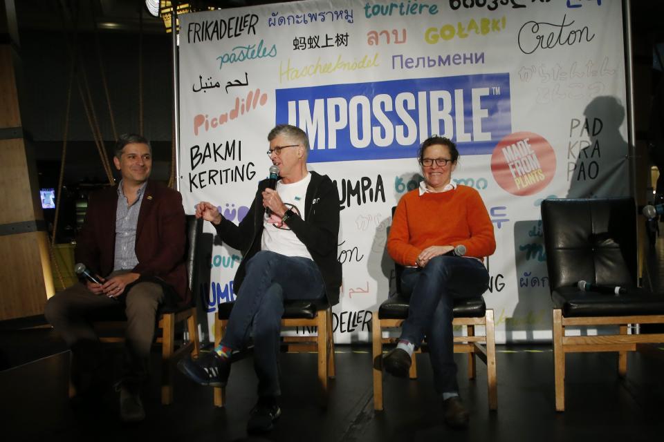 Dr. Patrick Brown, founder and CEO of Impossible Foods, the California plant-based meat company, unveils Impossible Pork and Impossible Sausage as he is flanked by Burger King CMO Fernando Machado, left, and chef and restaurant owner Traci Des Jardins, right, during a news conference before the CES tech show Monday, Jan. 6, 2020, in Las Vegas. (AP Photo/Ross D. Franklin)