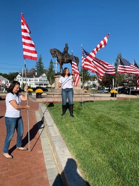 Citizens for Milford members plant flags at Draper Park in advance of Memorial Day.