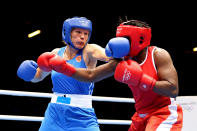 LONDON, ENGLAND - AUGUST 06: Nadezda Torlopova (Blue) of Russia competes against Edith Ogoke (Red) of Nigeria during the Women's Middle (75kg) Boxing Quarterfinals on Day 10 of the London 2012 Olympic Games at ExCeL on August 6, 2012 in London, England. (Photo by Scott Heavey/Getty Images)