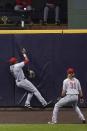 Cincinnati Reds' Phillip Ervin can't catch a home run hit by Milwaukee Brewers' Logan Morrison during the fourth inning of a baseball game Friday, Aug. 7, 2020, in Milwaukee. (AP Photo/Morry Gash)