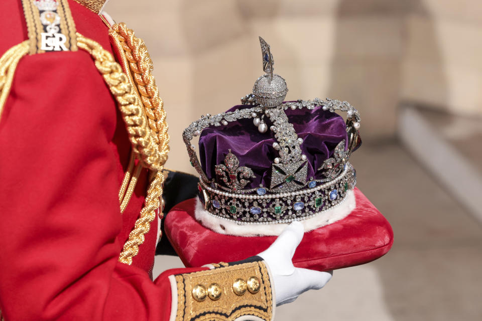 The Imperial State Crown is carried through the Sovereign's Entrance ahead of the State Opening of Parliament at Houses of Parliament, in London, Tuesday, May 10, 2022. Britain’s Parliament opens a new year-long session on Tuesday with a mix of royal pomp and raw politics, as Prime Minister Boris Johnson tries to re-energize his scandal-tarnished administration and revive the economy amid a worsening cost-of-living crisis. (Chris Jackson/Pool Photo via AP)