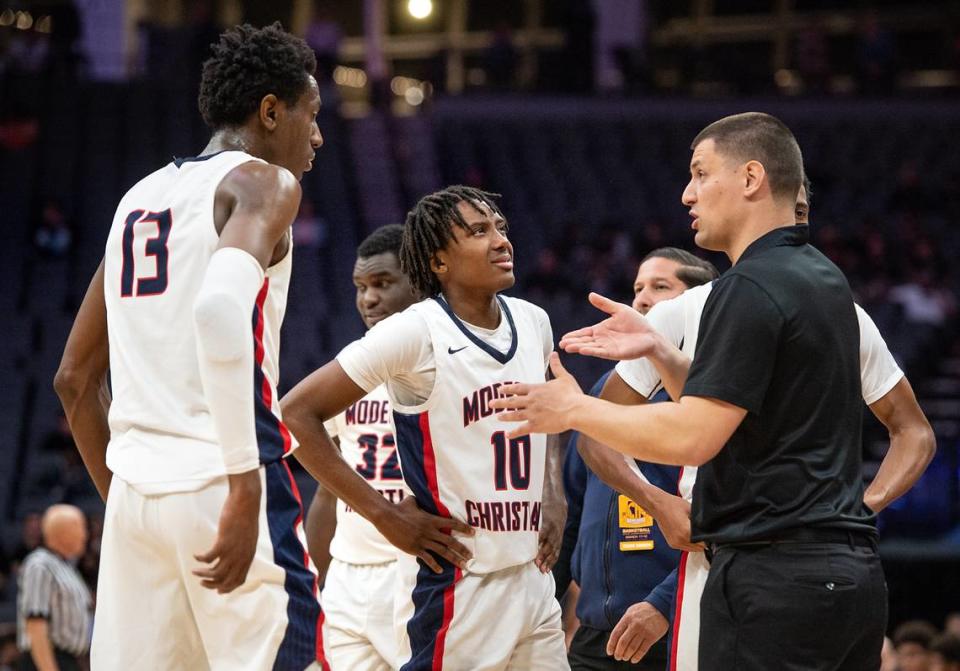 Modesto Christian coach Brice Fantazia, right, talks with Prince Oseya (13) during a timeout in the boys Open Division CIF State Basketball Championship game with Centennial at Golden 1 Center in Sacramento, Calif., on Saturday, March 12, 2022. Andy Alfaro/aalfaro@modbee.com