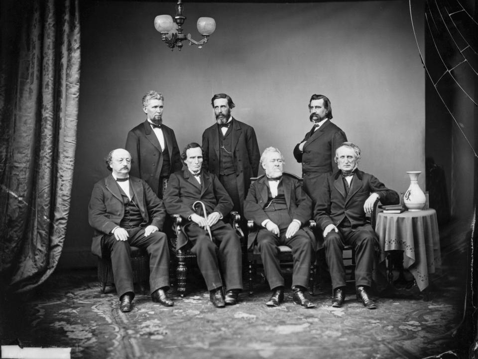 portrait of the House of Representatives' impeachment committee of President Andrew Johnson in 1868. Left to right (standing) are James F. Wilson, George S. Boutwell, and John A. Logan. Seated are (left to right) Benjamin F. Butler, Thaddeus Stevens, Thomas Williams, and John A. Bingham.