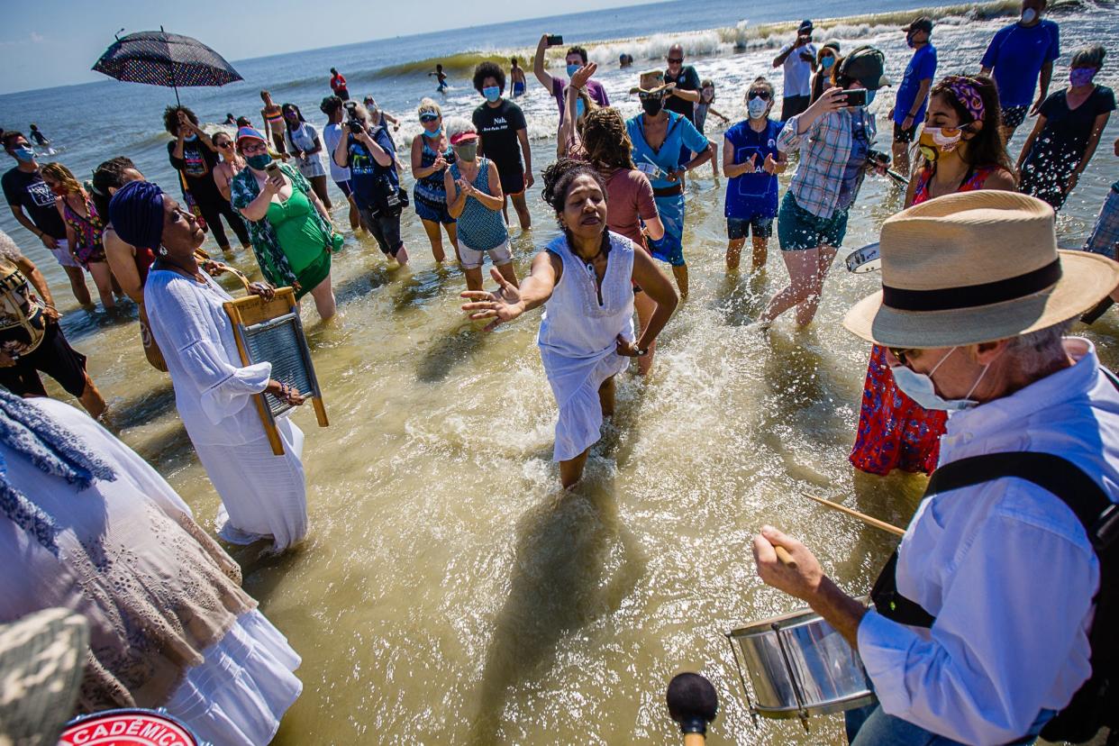 Participants dance in the ocean as they celebrate during the annual Juneteeth Wade In on June 19, 2020, on Tybee Island. Juneteeth is a celebration of the day Union Soldiers reached Galveston, Texas, with the news that the war had ended and enslaved people were free.