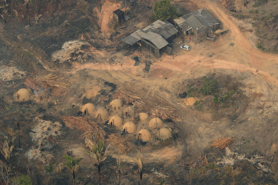 Charcoal-making furnaces and wooden planks are seen from the air, in the city of Jaci Parana, Rondonia state, Brazil, Saturday, Aug. 24, 2019. Brazil says military aircraft and 44,000 troops will be available to fight fires sweeping through parts of the Amazon region. The defense and environment ministers have outlined plans to battle the blazes that have prompted an international outcry as well as demonstrations in Brazil against President Jair Bolsonaro's handling of the environmental crisis. (AP Photo/Eraldo Peres)