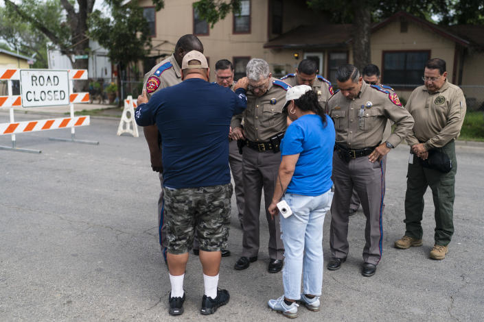 Texas Department of Public Safety Director Steven McCraw, center, prays with Pastor Gabriel Davila and wife, Sylvia, outside Robb Elementary School in Uvalde, Texas Monday, May 30, 2022. On May 24, 2022, an 18-year-old entered the school and fatally shot several children and teachers. (AP Photo/Jae C. Hong)