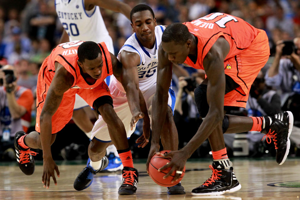 NEW ORLEANS, LA - MARCH 31: Russ Smith #2 and Gorgui Dieng #10 of the Louisville Cardinals go for the ball along with Doron Lamb #20 of the Kentucky Wildcats in the second half during the National Semifinal game of the 2012 NCAA Division I Men's Basketball Championship at the Mercedes-Benz Superdome on March 31, 2012 in New Orleans, Louisiana. (Photo by Ronald Martinez/Getty Images)