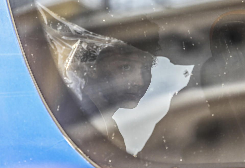 A survivor of latest tragical shipwreck looks out from a bus that will transfer him to Athens with other migrants and refugees at the port of Kalamata, Greece, Friday ,June 16, 2023. The round-the-clock effort continued off the coast of southern Greece despite little hope of finding survivors or bodies after none have been found since Wednesday, when 78 bodies were recovered and 104 people were rescued. (John Liakos/InTime News via AP)