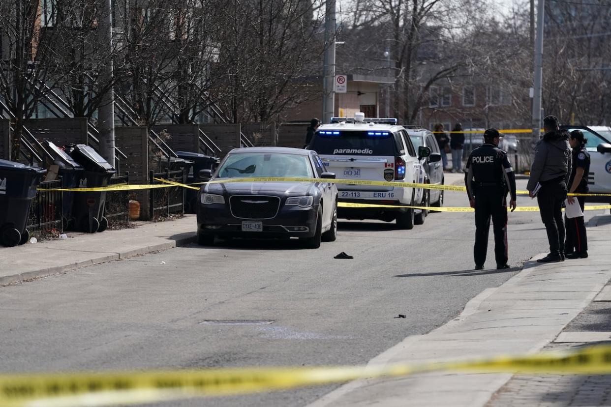 Police work the scene of a fatal shooting in downtown Toronto on Tuesday, March 12, 2024. (Arlyn McAdorey/The Canadian Press - image credit)