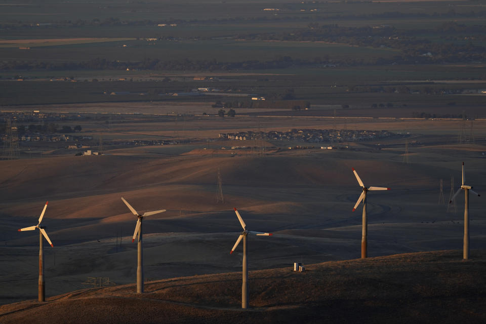 FILE - Wind turbines work in Livermore, Calif., Wednesday, Aug. 10, 2022. Massive incentives for clean energy in the U.S. law signed Tuesday, Aug. 16, by President Joe Biden should reduce future global warming “not a lot, but not insignificantly either,” according to a climate scientist who led an independent analysis of the climate package. (AP Photo/Godofredo A. Vásquez, File)