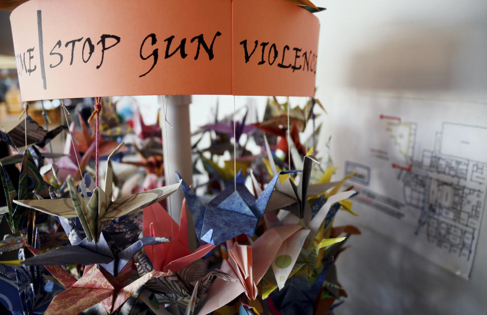 Paper cranes hang in the Columbine High School library in suburban Denver on Saturday, March 23, 2019. Several survivors and family members of the victims gathered at the library to speak about the upcoming 20th anniversary of the April 20, 1999, attack that killed 12 students and a teacher. (AP Photo/Thomas Peipert)