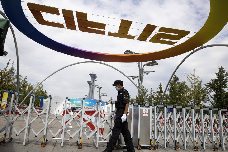 A security guard walks outside the venue for the China International Fair for Trade in Services (CIFTIS) to be held in Beijing on Friday, Sept. 4, 2020. As China recovers from the COVID-19 pandemic, business as usual is picking back up with the holding of the China International Fair for Trade in Services. Nearly 2,000 Chinese and foreign enterprises will participate and showcase their newest technology in public health and digital technology (AP Photo/Ng Han Guan)