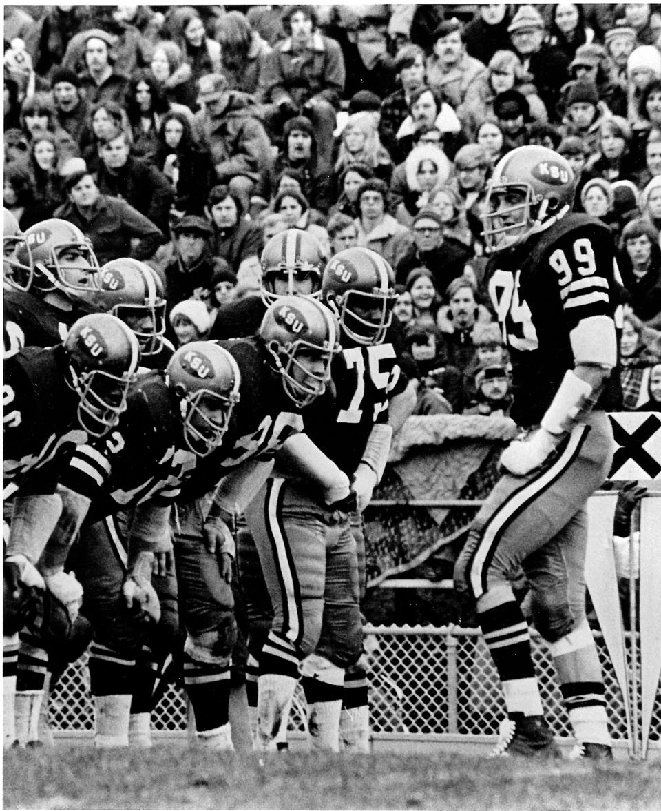 Kent State linebacker Jack Lambert (right) talks to his teammates in a defensive huddle in an undated photo.