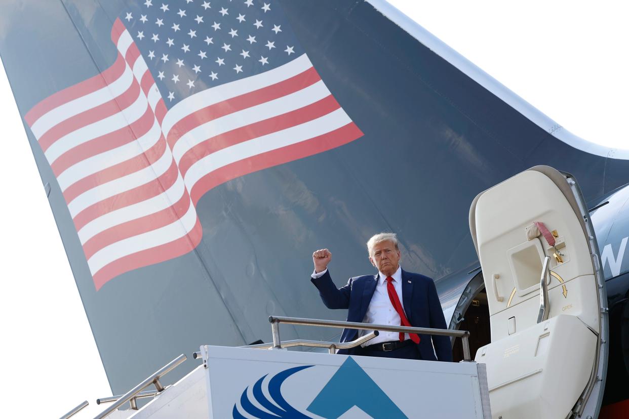 trump standing at trump force one plane