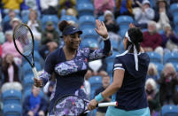 Serena Williams of the United States, left, and Ons Jabeur of Tunisia celebrate after wining their doubles tennis match against Marie Bouzkova of Czech Republic and Sara Sorribes Tormo of Spain at the Eastbourne International tennis tournament in Eastbourne, England, Tuesday, June 21, 2022. (AP Photo/Kirsty Wigglesworth)