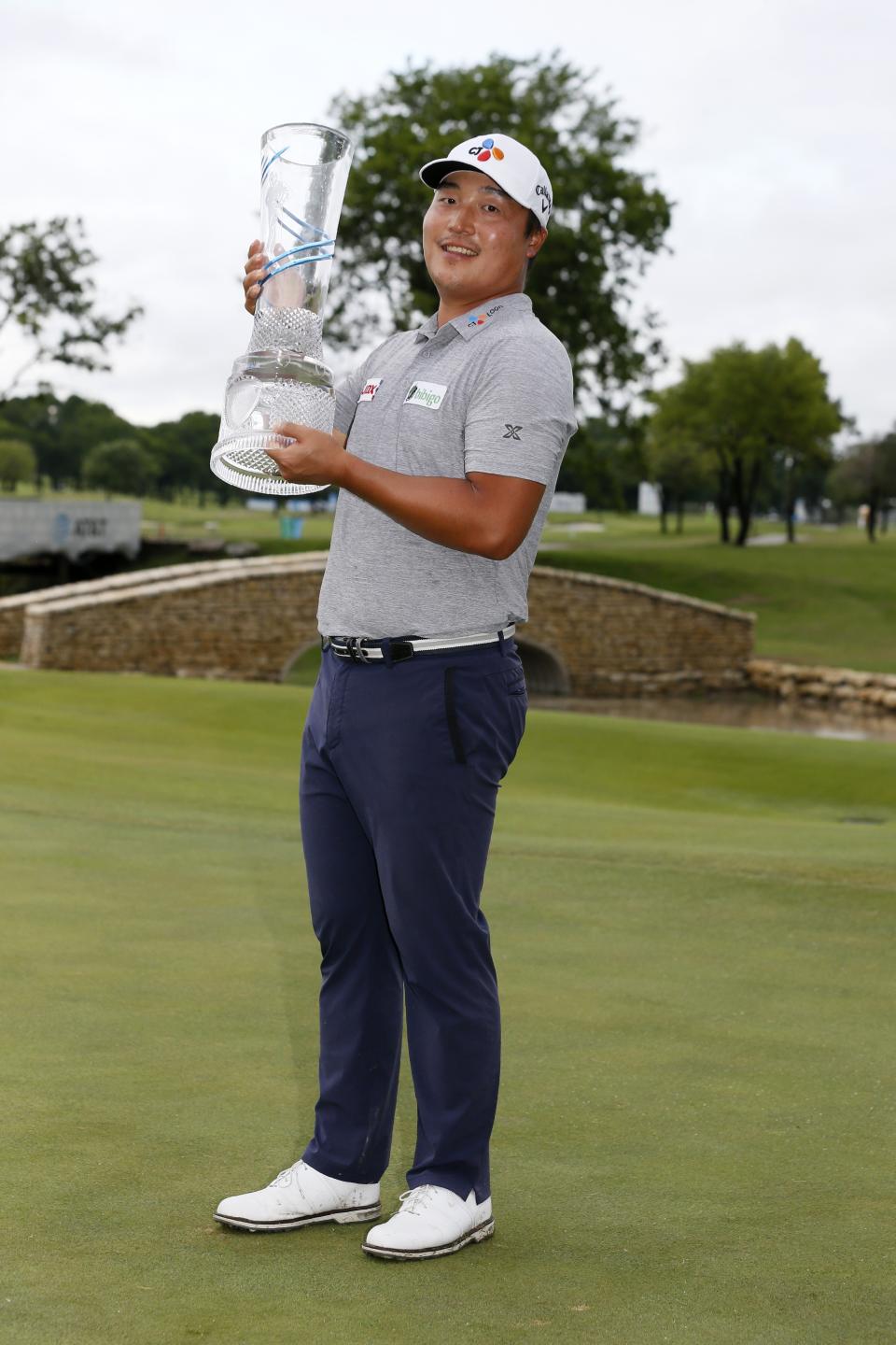 Kyoung-Hoon Lee, of South Korea, holds the trophy on the 18th green after winning the AT&T Byron Nelson golf tournament in McKinney, Texas, Sunday, May 16, 2021. (AP Photo/Ray Carlin)