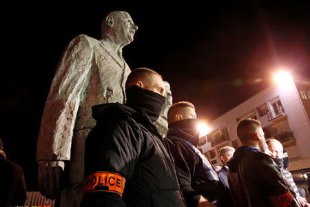 French plainclothes policemen gather in front of the statue of Charles de Gaulle and his wife, during an unauthorised protest against anti-police violence in Calais, France, late October 21, 2016. REUTERS/Pascal Rossignol