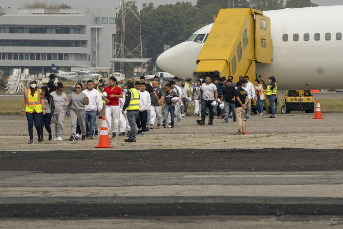 FILE - Guatemalan migrants who were deported from the U.S. deplane at La Aurora International Airport in Guatemala City, May 11, 2023. Mexico is flying migrants south away from the U.S. border and busing new arrivals away from its boundary with Guatemala to relieve pressure on its border cities. (AP Photo/Santiago Billy, File)