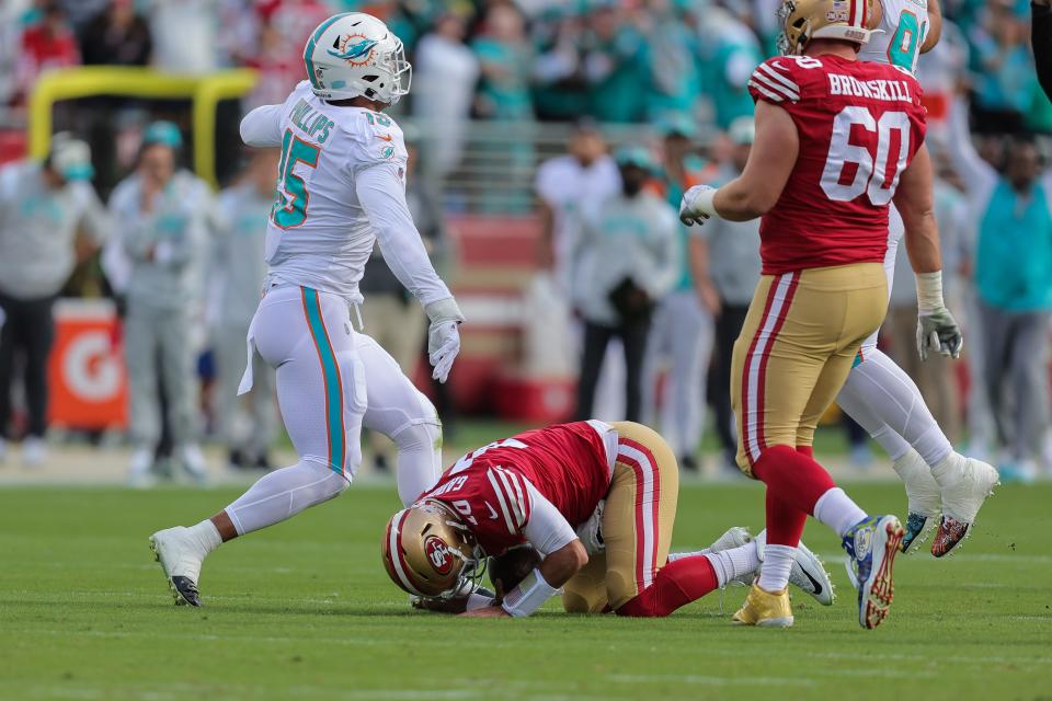 San Francisco quarterback Jimmy Garoppolo is sacked - and injured on the play - by Miami linebacker Jaelan Phillips (15) during the first quarter of Sunday's game in Santa Clara.