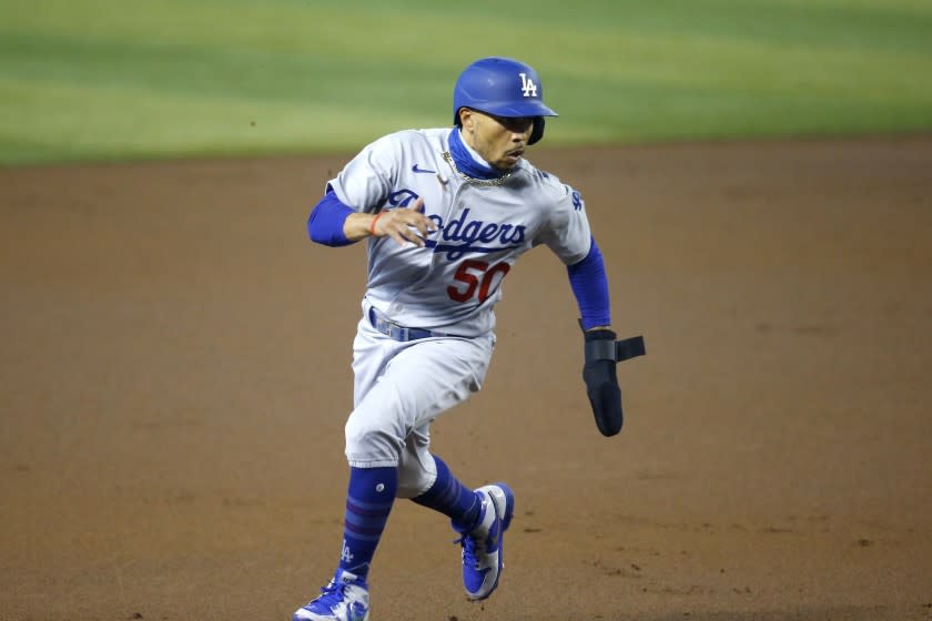 Los Angeles Dodgers' Mookie Betts runs to third base against the Arizona Diamondbacks.