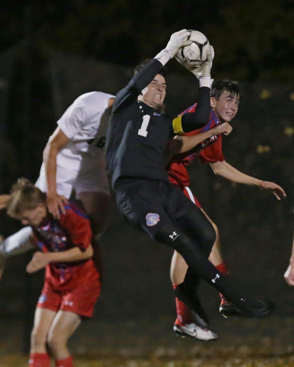 Fairport goalkeeper Aiden Nelson goes up to grab a corner kick near his goal during their Section V Class AAA championship final Friday, Oct. 27, 2023 at Spencerport.