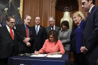House Speaker Nancy Pelosi of Calif., signs the resolution to transmit the two articles of impeachment against President Donald Trump to the Senate for trial on Capitol Hill in Washington, Wednesday, Jan. 15, 2020. The two articles of impeachment against Trump are for abuse of power and obstruction of Congress. (AP Photo/Susan Walsh)