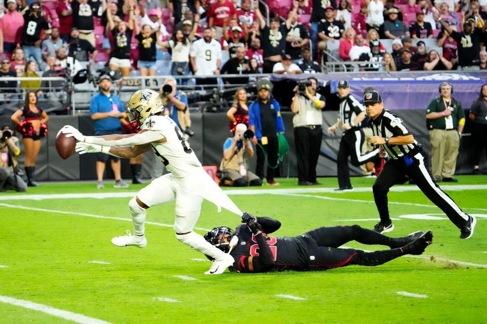 Oct 20, 2022; Glendale, Arizona, USA; New Orleans Saints wide receiver Rashid Shaheed (89) scores a touchdown as Arizona Cardinals cornerback Marco Wilson (20) hangs-on to his jersey in the first half at State Farm Stadium. Mandatory Credit: Rob Schumacher-Arizona Republic