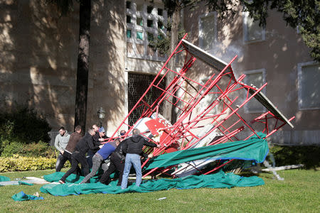 Supporters of the opposition party try to break an art instaliation in front of the office of Prime Minister Edi Rama during an anti-government protest in Tirana, Albania, February 16, 2019. REUTERS/Florion Goga