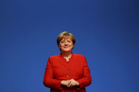 German Chancellor and leader of the conservative Christian Democratic Union party CDU Angela Merkel reacts after she was re-elected as chairwoman at the CDU party convention in Essen, Germany, December 6, 2016. REUTERS/Kai Pfaffenbach