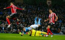 Manchester City's Argentinian striker Sergio Aguero clashes with Southampton's goalkeeper Maarten Stekelenburg (bottom) during the English Premier League football match at The Etihad stadium in Manchester, England on November 28, 2015