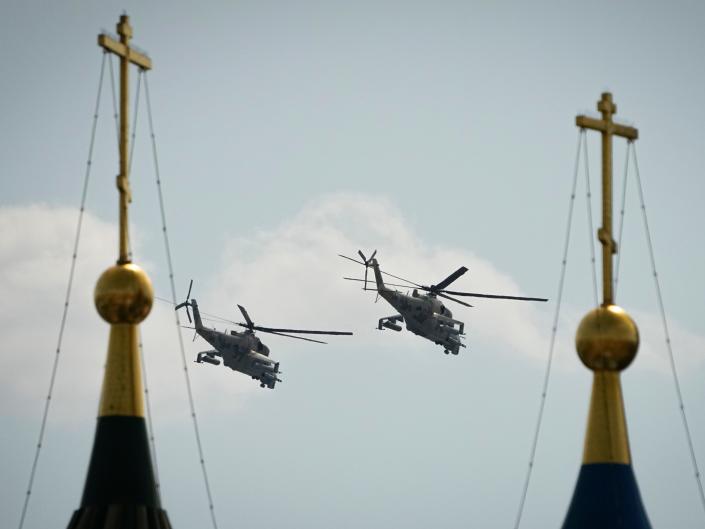 Russian military helicopters fly over Red Square during a dress rehearsal for the Victory Day military parade in Moscow, Russia, Saturday, May 7, 2022.