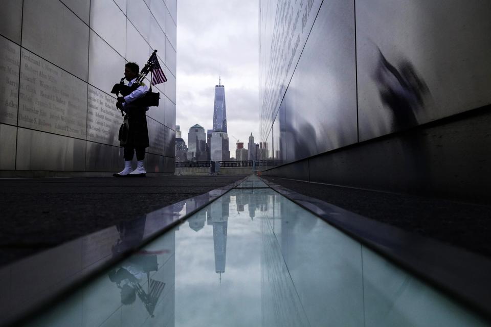 A firefighter memorial bagpiper visits the 9/11 Empty Sky memorial during the 13th anniversary of the 9/11 attacks on the World Trade Center, in Jersey City, New Jersey, September 11, 2014. Until a few months ago, the part of New York City where crowds will gather on Thursday morning to mark the 13th anniversary of the September 11 attacks on the United States had been mostly fenced off to the public.This year, for perhaps the first time since the attacks, a sense of normalcy and openness has taken root in the city blocks where two airliners hijacked by militants from al Qaeda crashed into the World Trade Center's twin towers. (REUTERS/Eduardo Munoz)