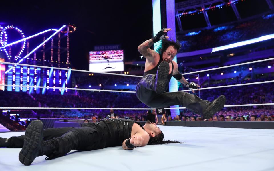 The Undertaker legdropping Roman Reigns - WWE