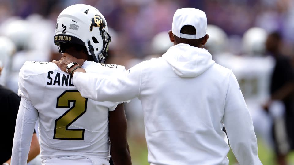 Shedeur Sanders of the Colorado Buffaloes with his father, head coach Deion Sanders, before Colorado's game against the TCU Horned Frogs on September 2, 2023, in Fort Worth, Texas. Colorado won 45-42. - Ron Jenkins/Getty Images