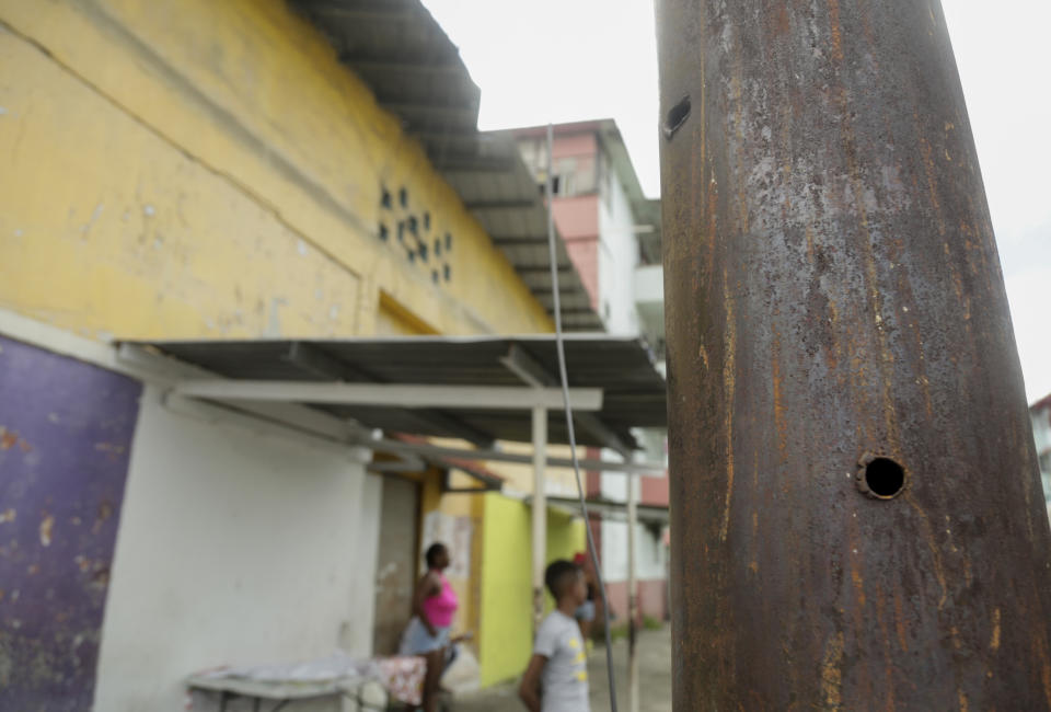 In this Dec. 1, 2019, bullets holes pierce a street lamp pole, which residents say were made during the night of the 1989 U.S. invasion, in the El Chorrillo neighborhood where former Gen. Manuel A. Noriega operated his headquarters and is an area that was targeted for attack in Panama City. Today this area still has desolate parts where residents say bombs fell and where graffiti with phrases like “Forbidden to forget” and “Dec. 20, national mourning” cover the walls. (AP Photo/Arnulfo Franco)