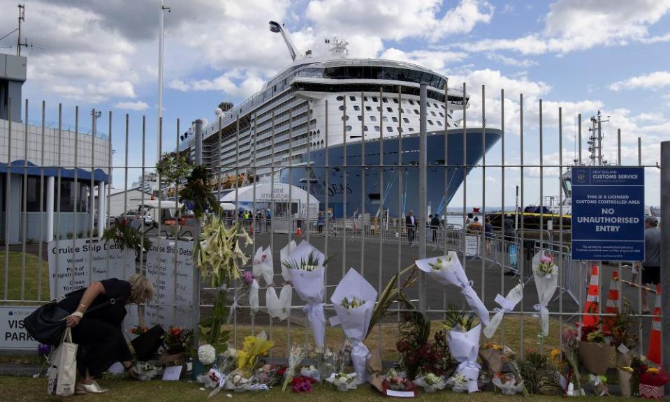 Flowers line the fence entrance to Port of Tauranga for victims of the White Island eruption