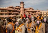 Naga Sadhus, or Hindu holy men wearing face masks wait before the procession for taking a dip in the Ganges river during Shahi Snan at "Kumbh Mela", or the Pitcher Festival, amidst the spread of the coronavirus disease (COVID-19), in Haridwar